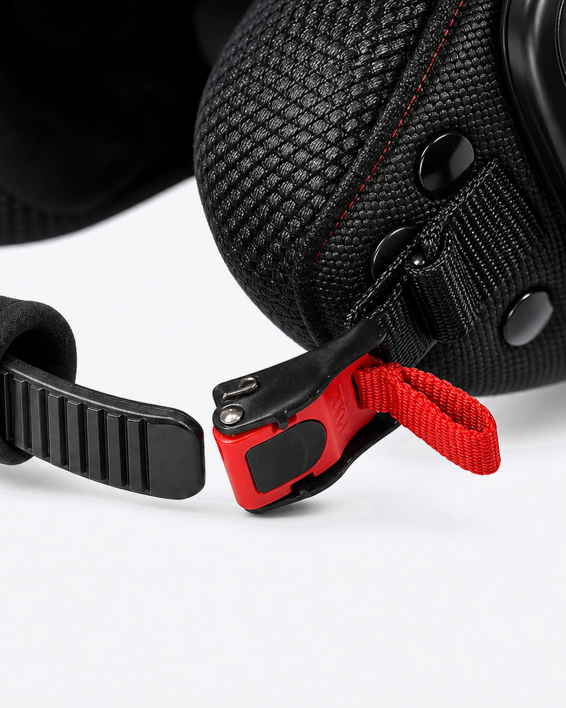 Scooter quick-release buckle on the chin strap, red tab open